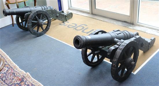 A pair of cast iron model cannons W.60cm